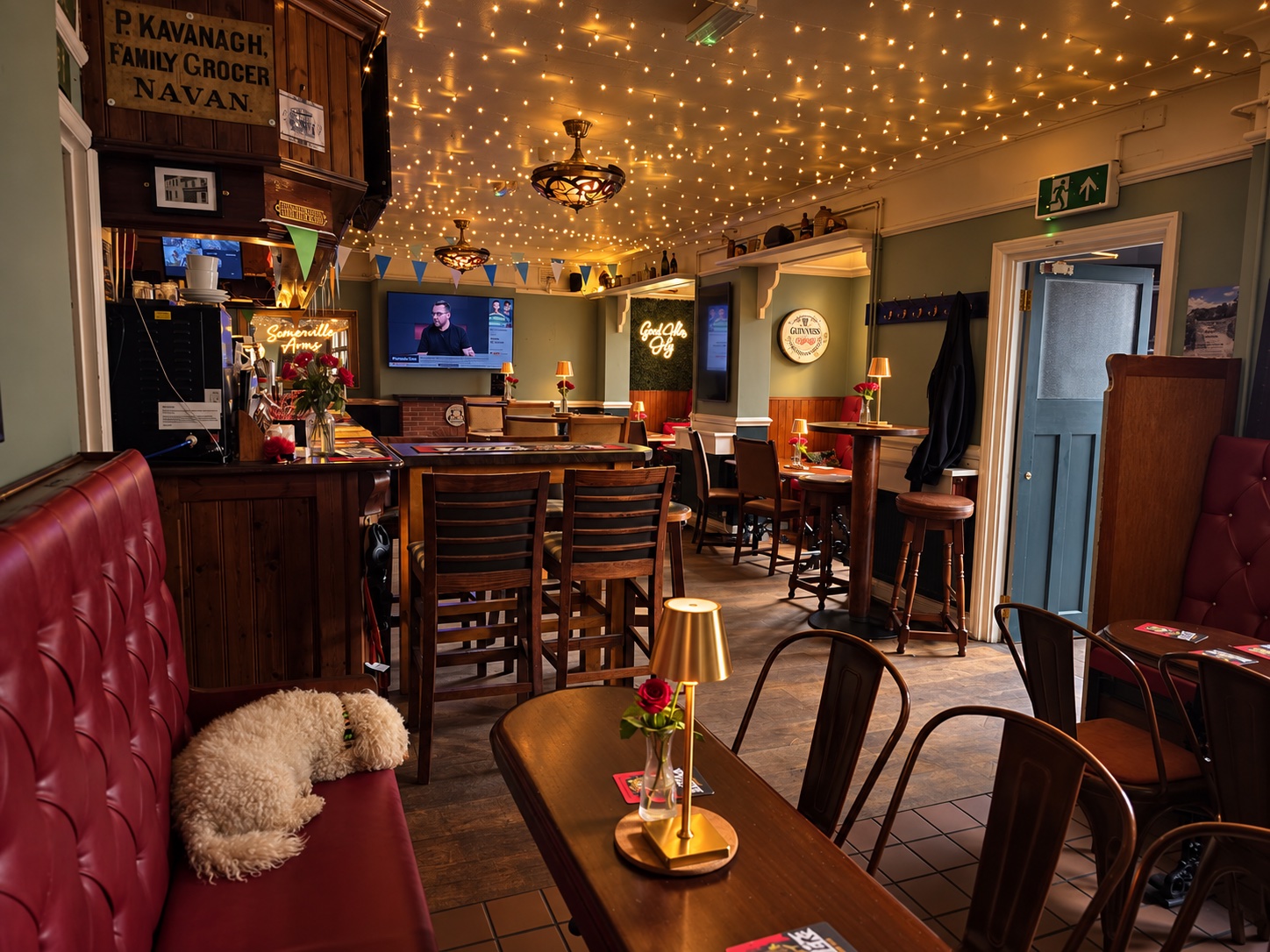 Red leather seating and wooden tables beside the bar